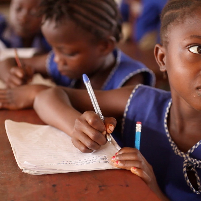A young girl listens writing in her notebook in class in Sierra Leone. Credit: GPE/Stephan Bachenheimer
