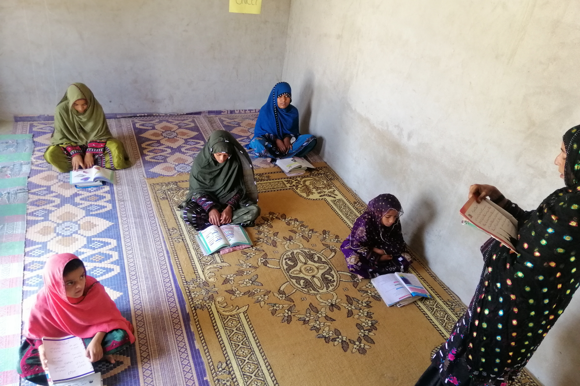  Ms. Najeeba, a higher secondary school student, is teaching her young siblings in her home located at Tawakal Bazar Mundi, District Gwadar, Balochistan, under the Mera Ghar Mera School (My Home My School) program. Tawakal Bazar Mundi,  Tehsil Gwadar, District Gwadar, Balochistan. Credit: UNICEF/Adil Nodezai, District Manager, Gwadar, Balochistan